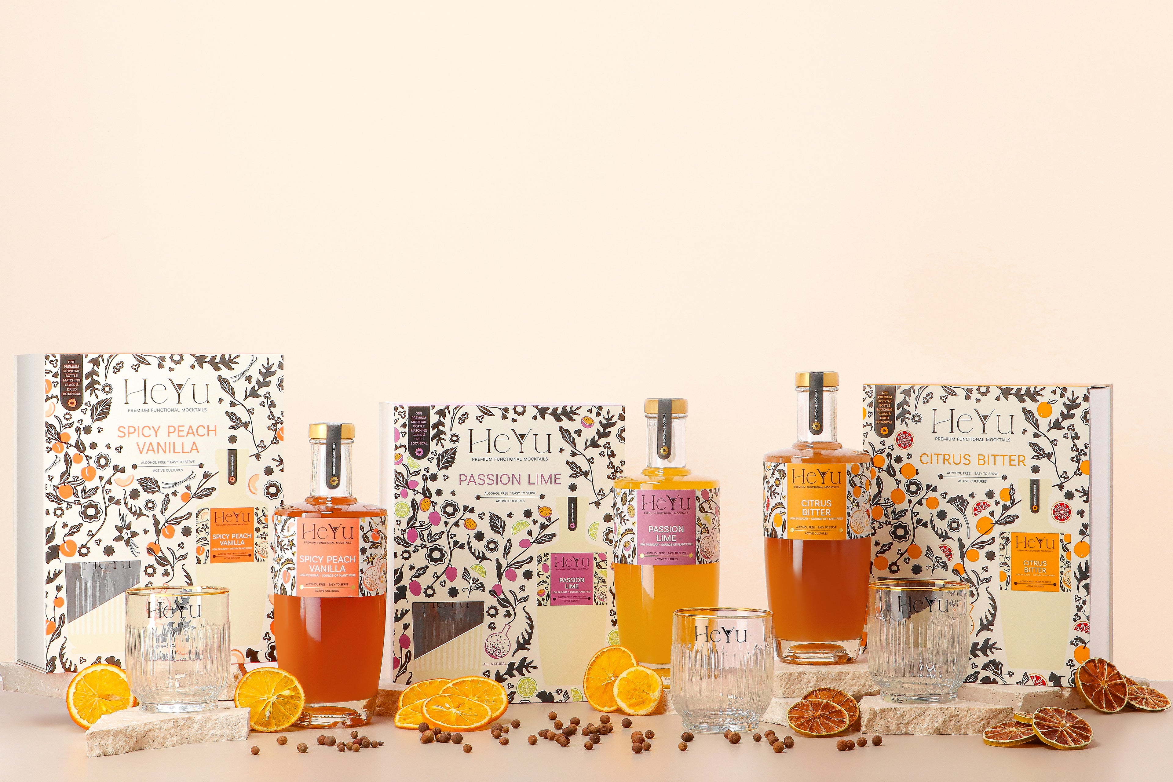 Overview picture of all three flavors of Heyu giftboxes is displayed in the background with glasses of how to serve the mocktails.
